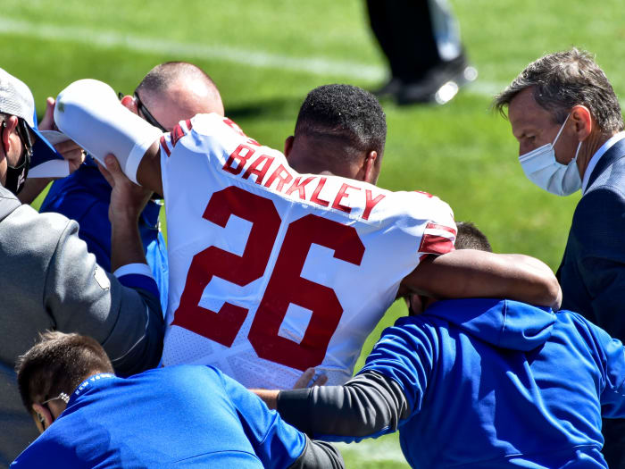 Sep 20, 2020; Chicago, Illinois, USA; New York Giants running back Saquon Barkley (26) is helped off the field after suffering an injury during the second quarter against the Chicago Bears at Soldier Field.